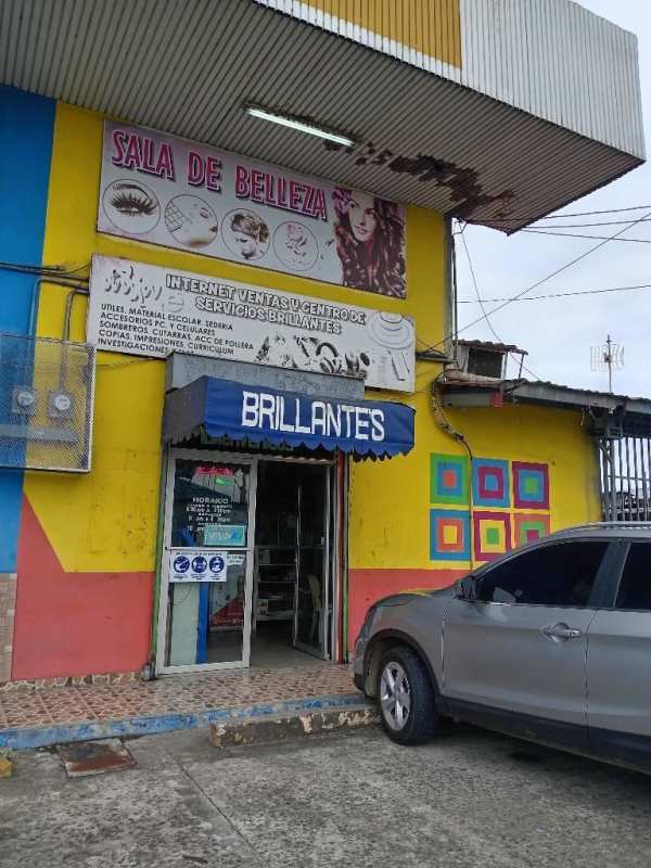 Colorful facade of a beauty salon and retail shop with parked car Tocumen Commercial Plaza