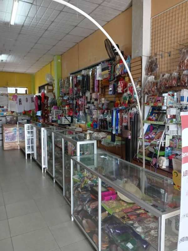 Retail store interior with glass display counters and advertising banners in Tocumen Panama