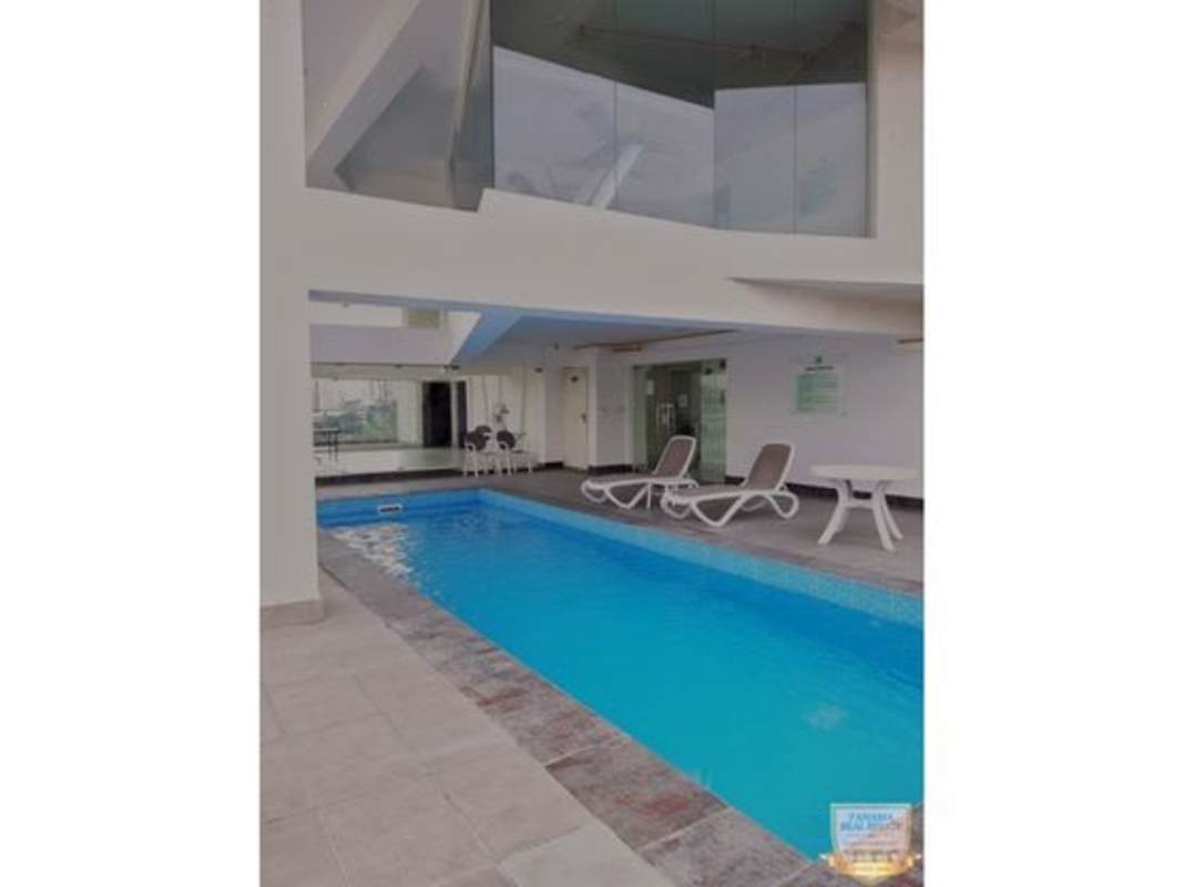 Indoor swimming pool with lounge chairs and loft overlook at PH Parques del Carmen El Carmen Panama