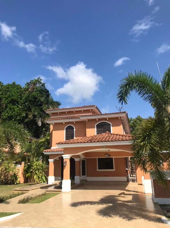 Two-story Mediterranean-style home in Clayton with clay tiles, arches