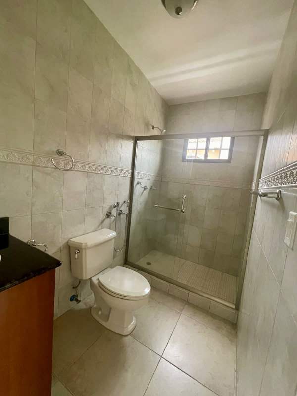 Bathroom tiled with glass enclosed shower vanity mirror Clayton house