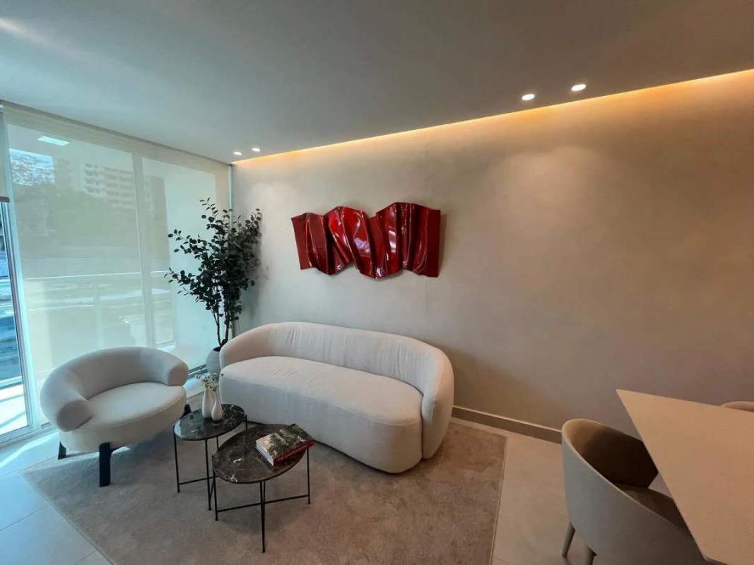 Living room with curved sofa, balcony view Condado Gardens Condado del Rey Panama