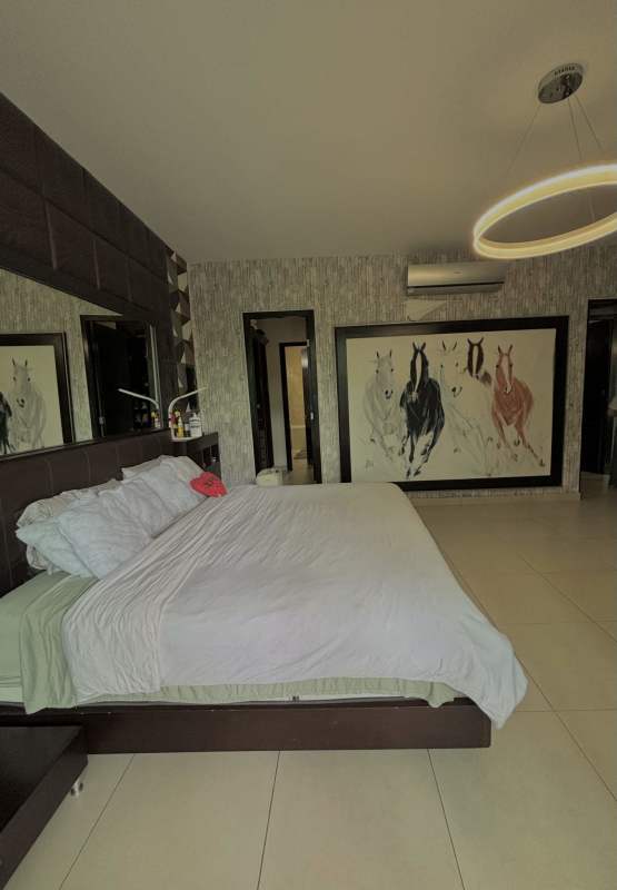 Spacious bedroom with walk-in closet, large window overlooking garden at The Bridge Amador Panama