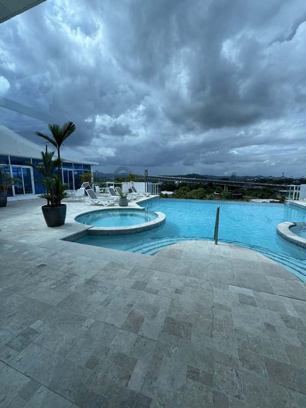 Luxury infinity pool and jacuzzi on rooftop with canal and city skyline views at The Bridge Amador Panama