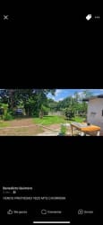 Entrance yard with lawn and mature trees near Super Xtra La Chorrera