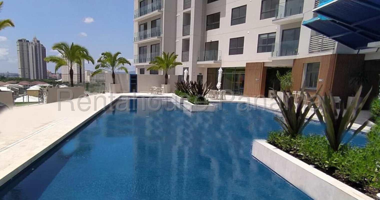 Luxury swimming pool with sun loungers and palm trees at PH Ocean House in Santa Maria, Panama City