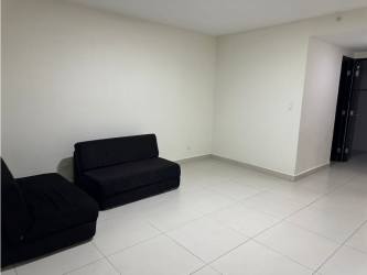 Bright living room with large sliding glass doors to balcony in PH Midrise Panama Pacifico