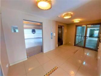 Open kitchen with granite countertops, black cabinets and pendant lights in PH Midrise