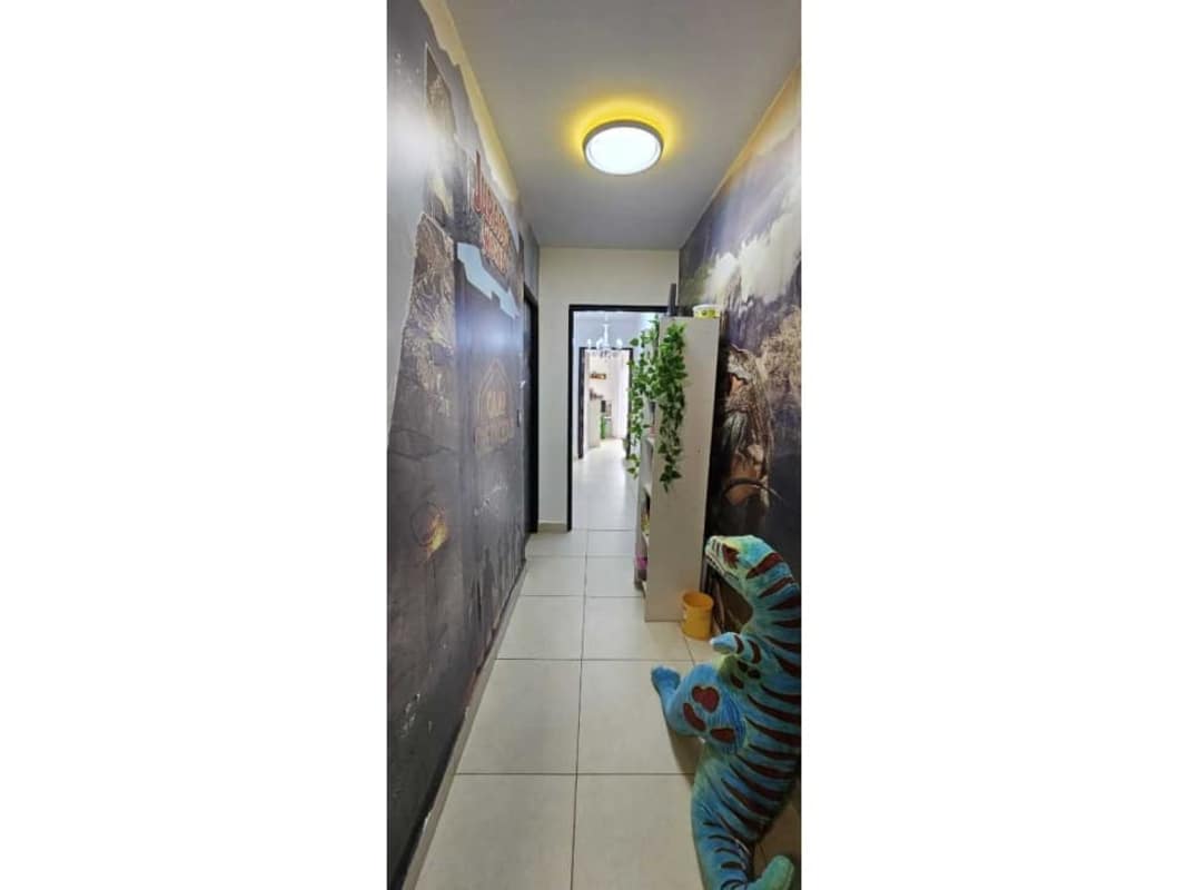 Modern bathroom with double sink vanity, large mirror and walk-in glass shower in Embassy Village Panama