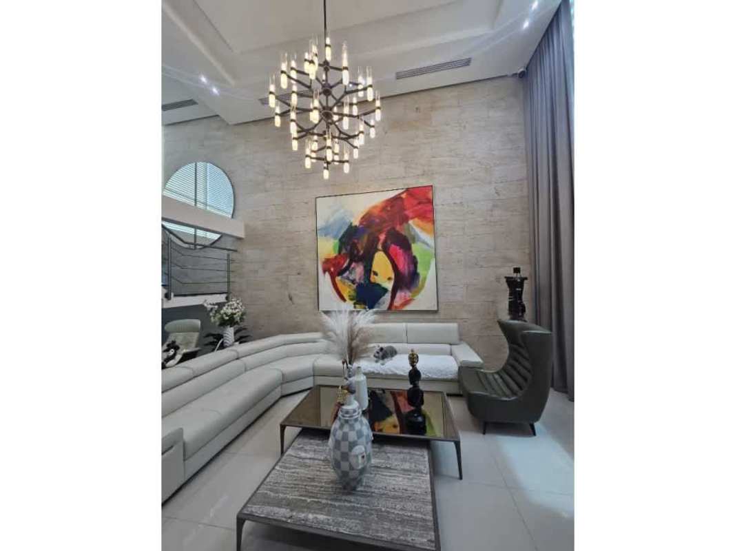 Modern luxury living space double height abstract art chandeliers Costa Esmeralda