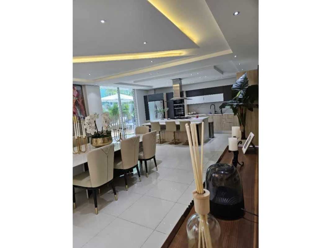 Modern open plan kitchen dining area marble island stainless appliances Costa Esmeralda Panama house