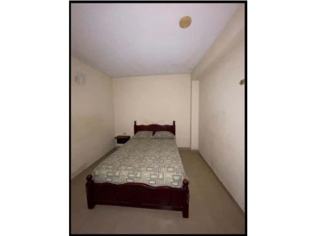 Simple bathrooms with pedestal sinks and tiled walls inside Calidonia commercial investment building Panama