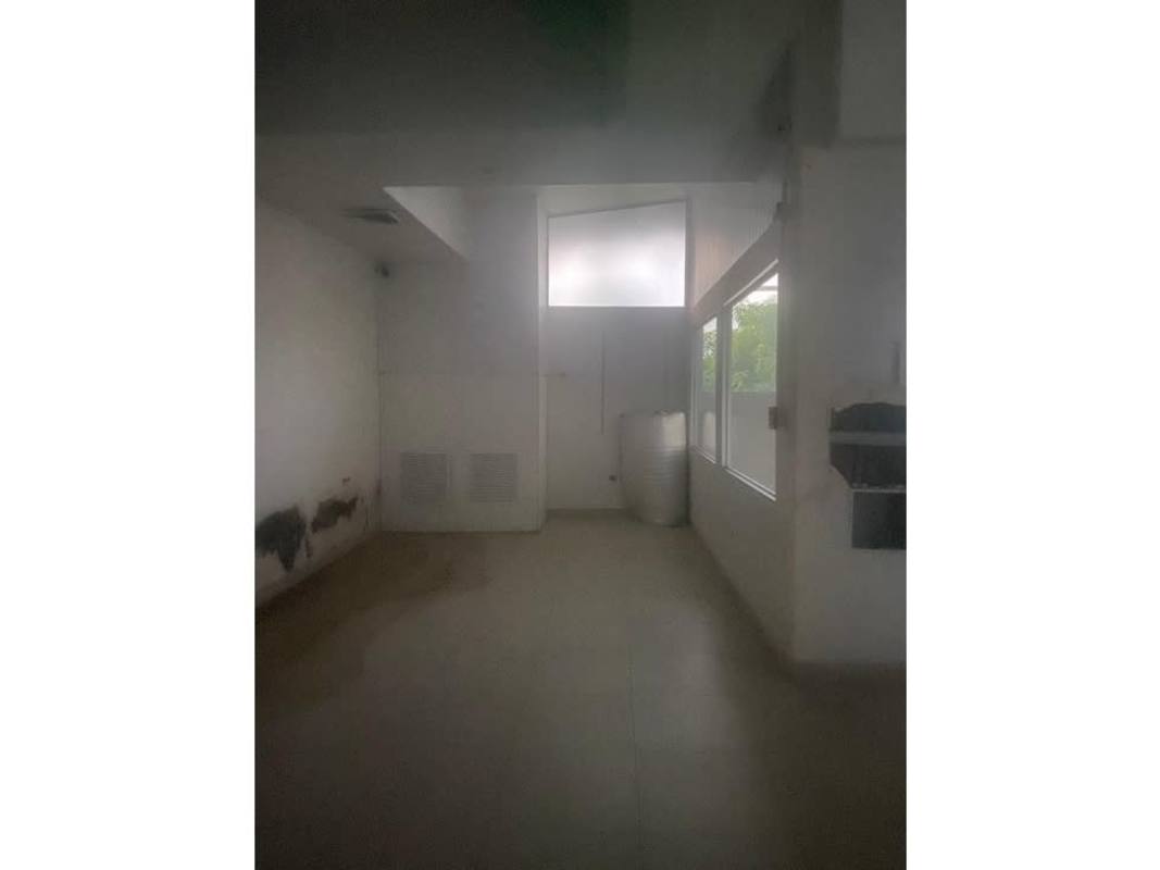 Dim utility room with large window suitable for storage or office space in Los Angeles Bethania