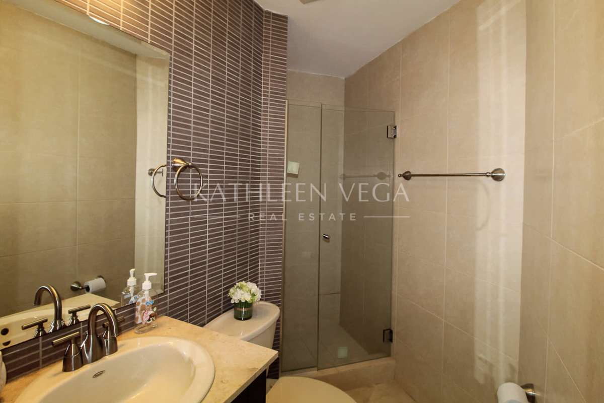 Contemporary bathroom with glass enclosed shower marble countertop at PH Riverside Costa del Este Panama