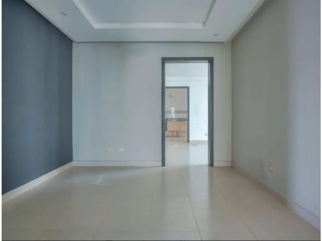 Bright bedroom with large window overlooking Panama City skyline Tao Tower San Francisco