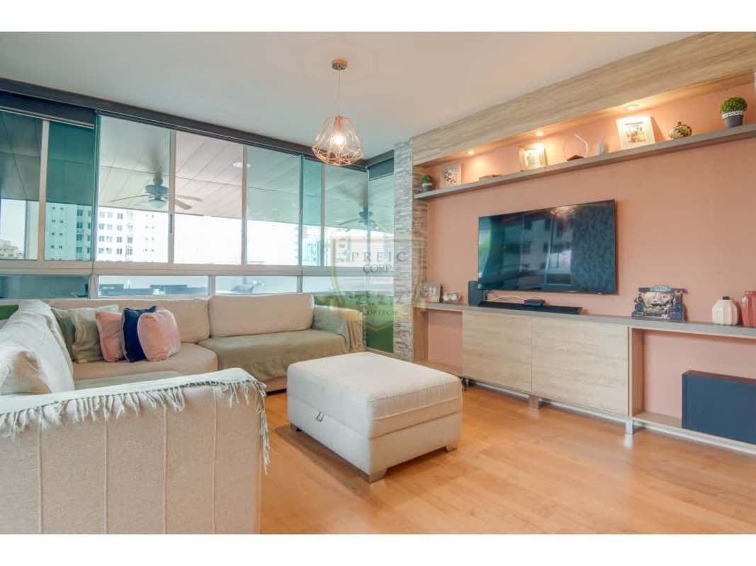 Bright contemporary living dining room with wood floors, accent wall, large windows in PH Cangrejo 507 Vía Argentina Panama