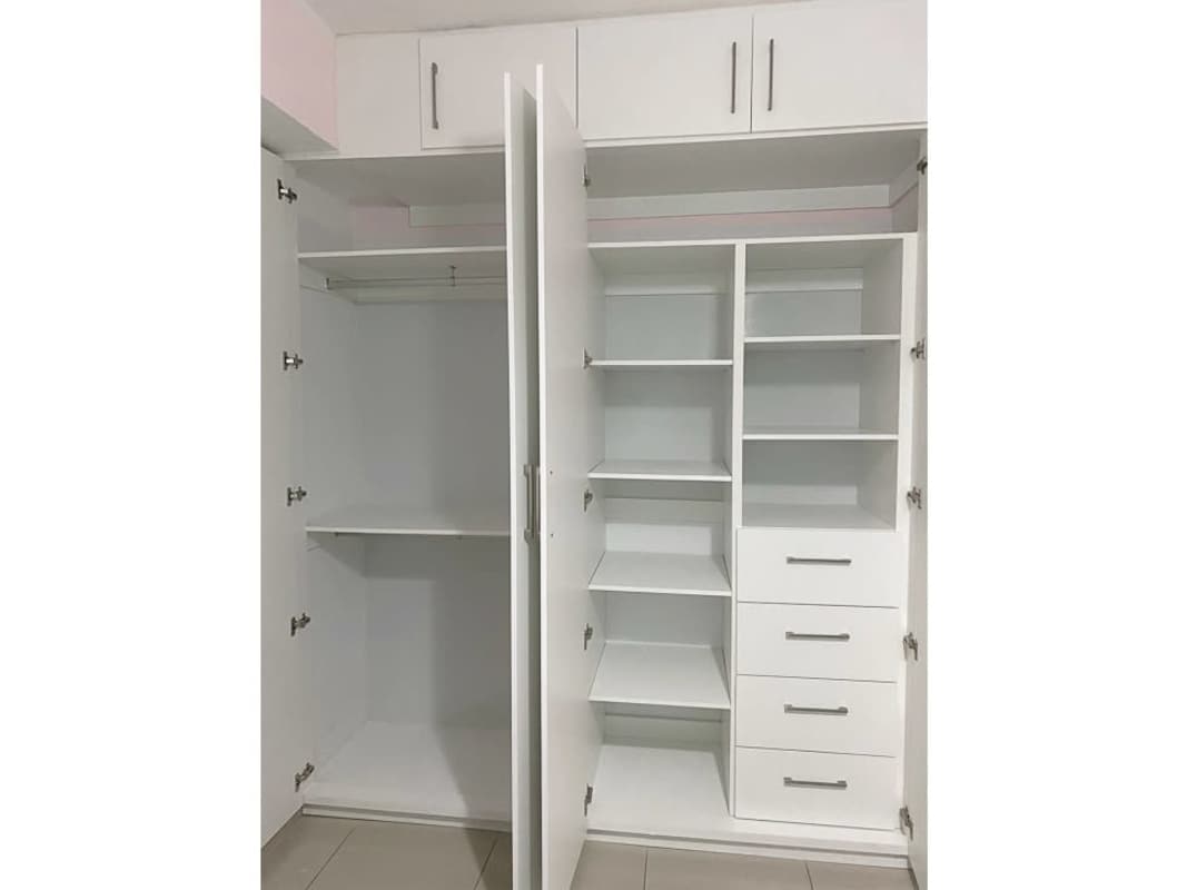 Large walk-in closet with built-in organizers inside PH The Regent apartment in San Francisco Panama
