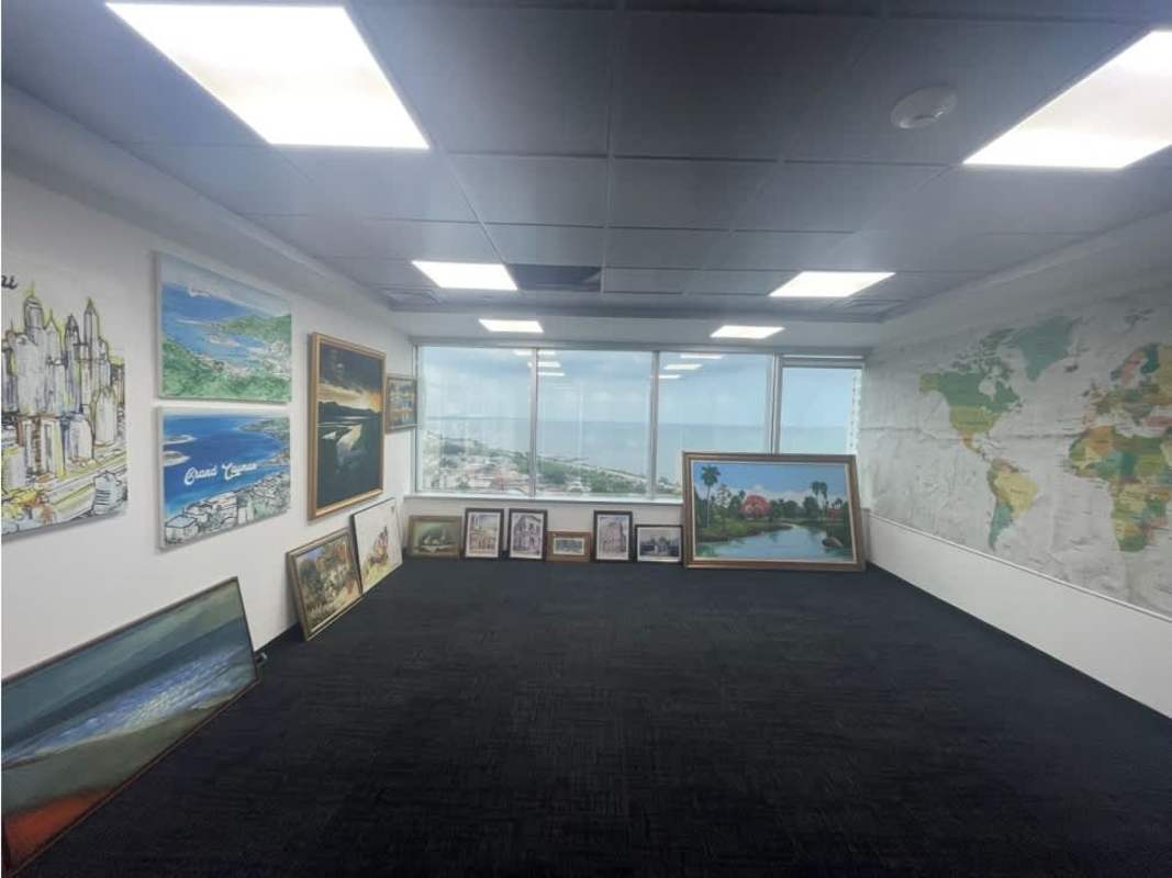 Office room with large windows, murals and expansive city and ocean views