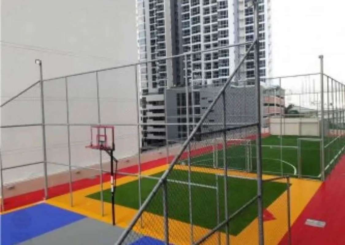 Multi-purpose sports court on rooftop of PH Sky Park with city skyline views