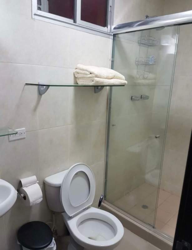 Bathroom with glass shower enclosure and modern fixtures at PH Sky Park Panama City