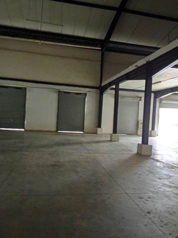 Warehouse interior with multiple rolling shutter doors concrete floor in Pacora Panama