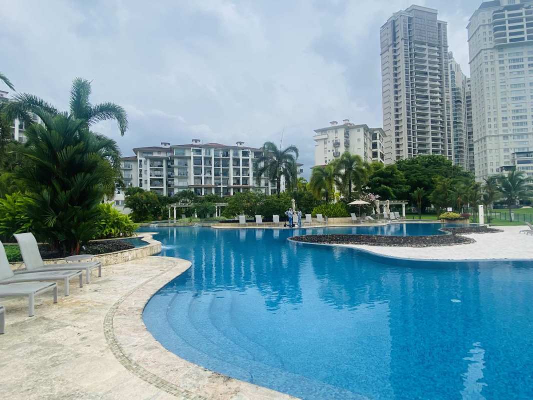 Exclusive swimming pool with lush tropical landscaping at PH The Reserve Santa María Panama City