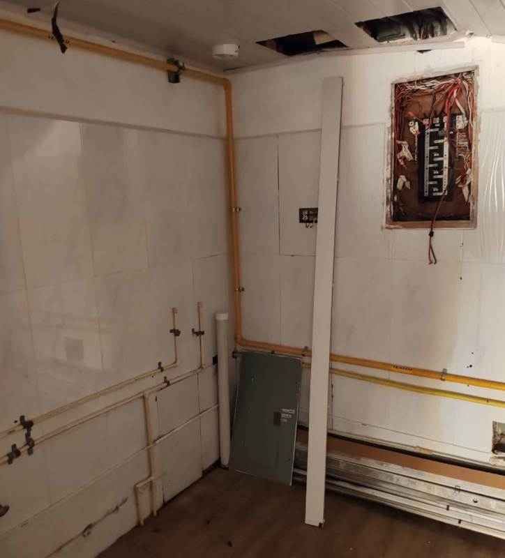 Unfinished utility area with electrical panels and exposed pipework Plaza San Francisco unit Panama