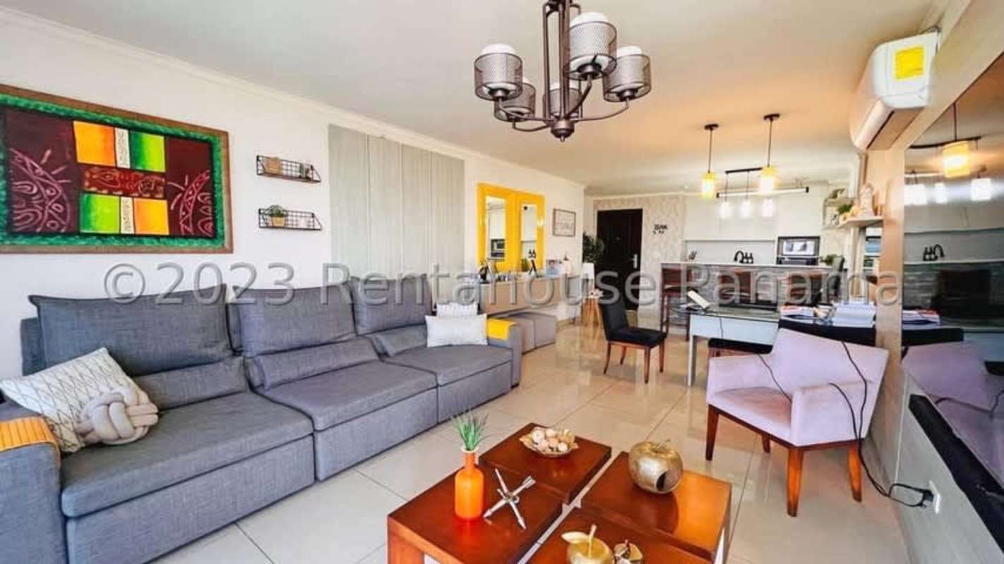 Modern living room with sectional sofa, dining area, view into kitchen PH Portofino Villa de las Fuentes Panama