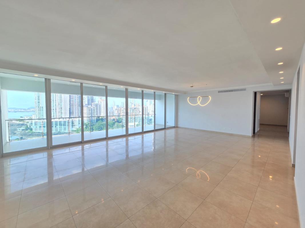 Bright living room with ocean view floor-to-ceiling windows marble flooring in luxury condo PH Aqualina Panama City