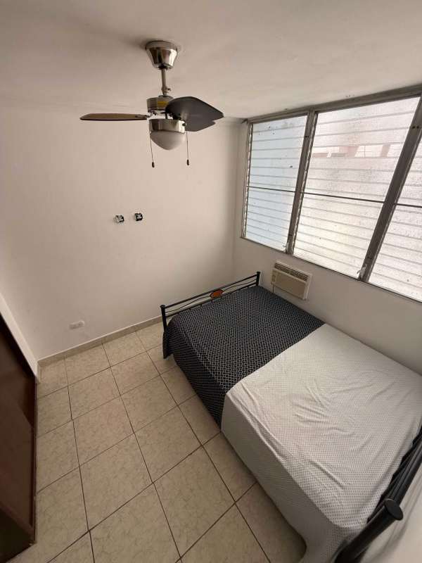 Dining room with large windows, wood floors, modern lighting in PH St Emillion Panama rental