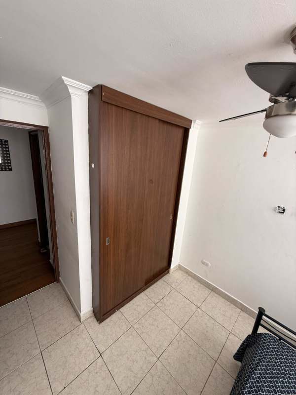 Modern living room with gray sofa, flat TV, air conditioning PH St Emillion Panama apartment rental