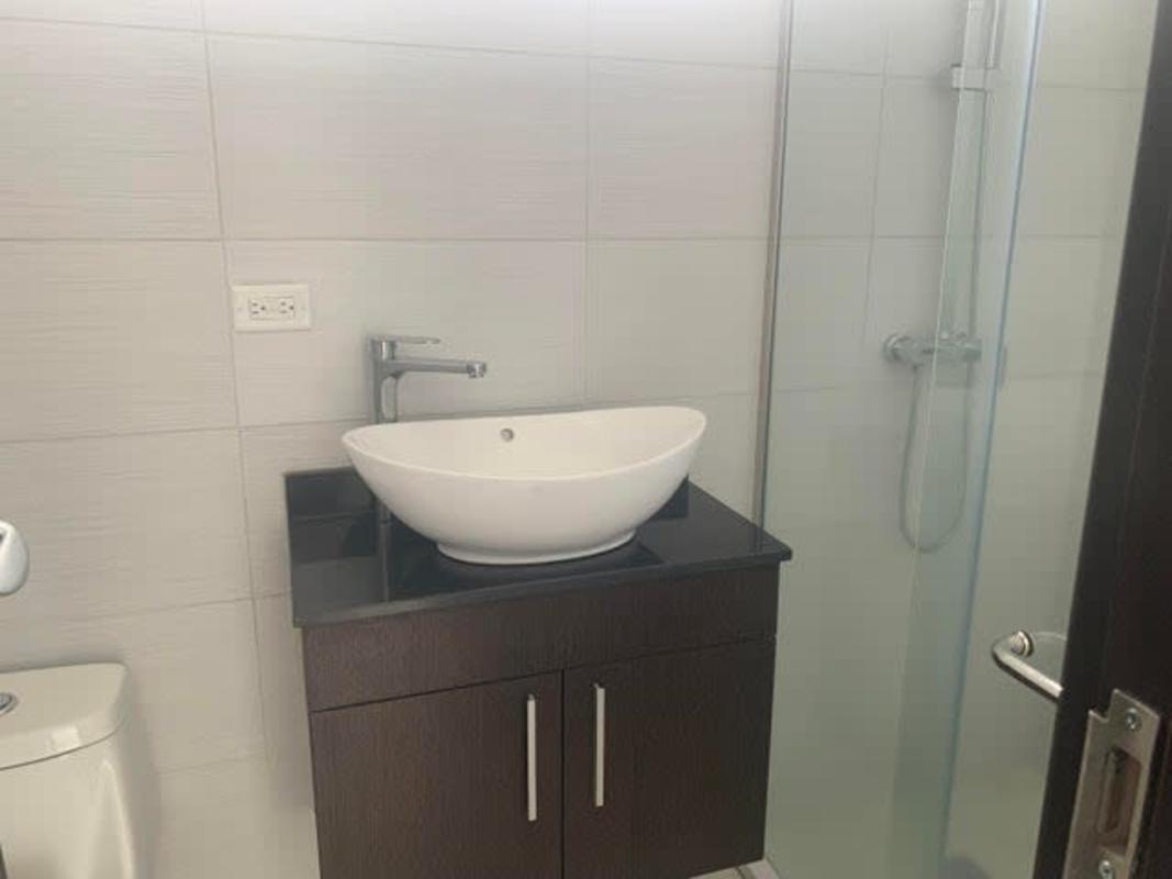 Bedroom with large window overlooking city skyline in PH Carreras Panama