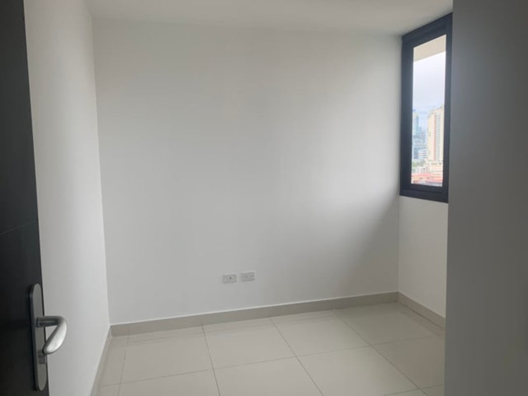 Minimalist empty room with window and tile flooring in PH Carreras Panama City