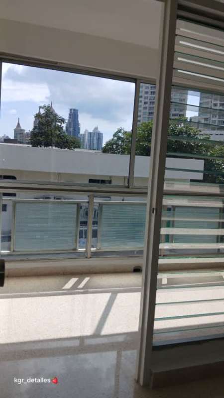Living room with large sliding windows and balcony access at PH Baleares Panama