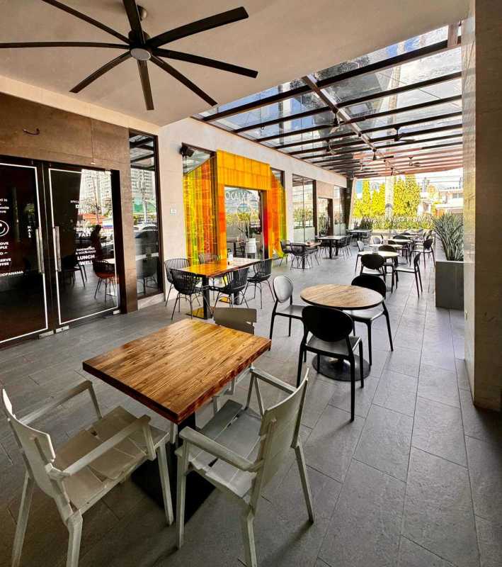 Empty open commercial unit with industrial finish, marble floors, large window in Panama City