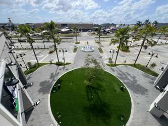 Circular courtyard with fountain, palm trees, pedestrian paths in Costa Verde La Chorrera