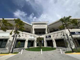 Two-story Mediterranean shopping plaza with palm trees and balconies at Costa Verde Panama