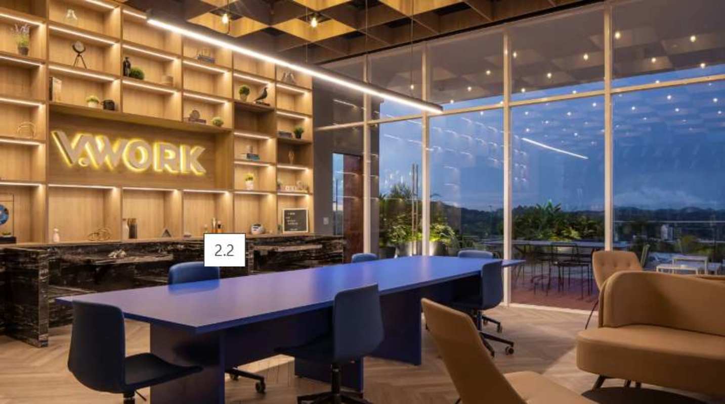 Bright coworking space with floor-to-ceiling windows, conference table and city skyline at PH El Cangrejo Panama