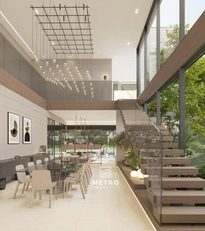 Modern double-height living and dining area with large windows overlooking garden in Santa Maria Panama