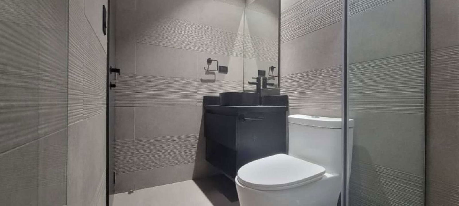 Minimalist bathroom with black vanity vessel sink Victory Wellness Coco del Mar Panama