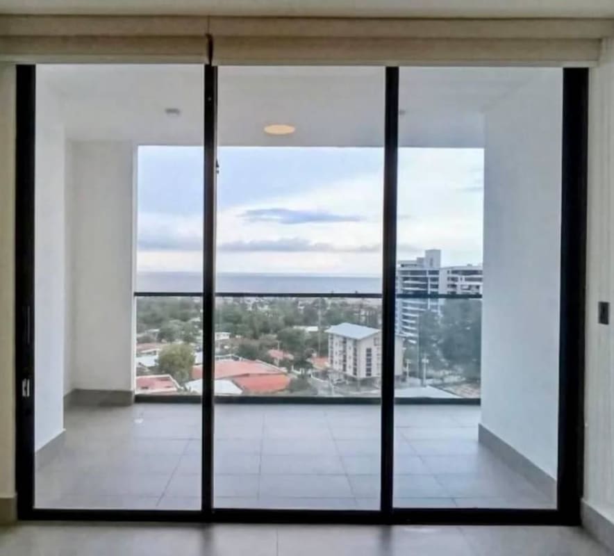 Spacious living room with sliding glass doors to balcony at Victory Wellness Panama City