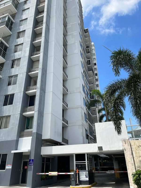 Modern high-rise PH Cosmopolitan Tower facade with balconies and palm trees Panama City