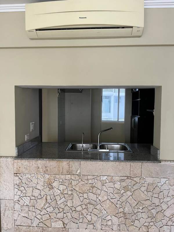 Outdoor pool with umbrellas, children's playhouse and landscaped gardens at Cosmopolitan Tower Panama