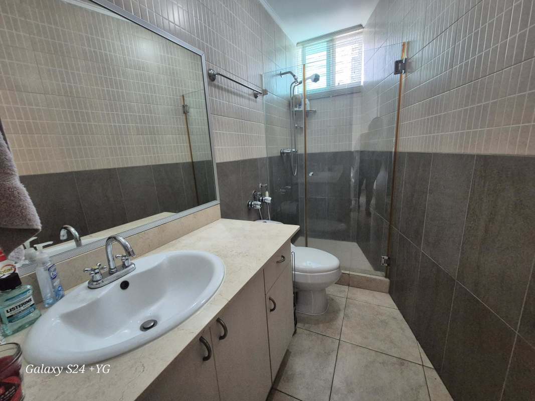 Modern bathroom with glass shower enclosure and sink at PH 7400 Panama