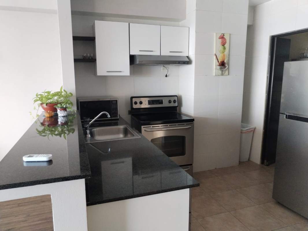 Furnished apartment kitchen with granite counters and appliances in PH Bayfront Panama City