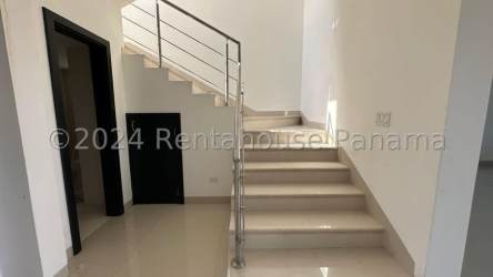 Contemporary stairs with metal railing inside beach home San Carlos Panama