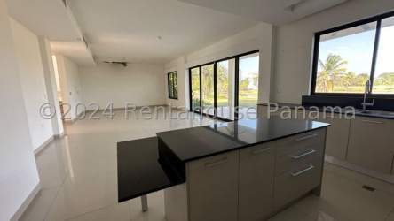 Modern kitchen area with granite island and large windows in San Carlos Panama beach home