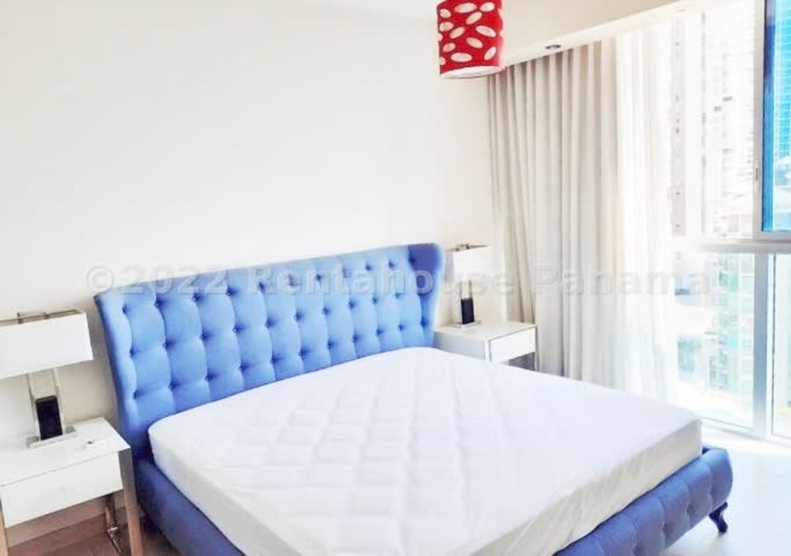 Modern kitchen with granite countertops, built-in appliances, and adjacent laundry in Grand Tower Punta Pacifica Panama