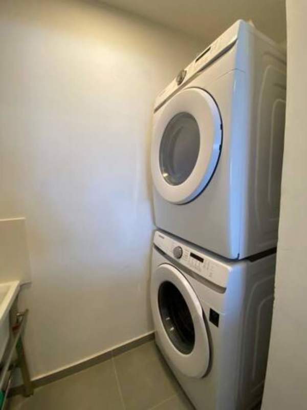 Compact laundry area with stacked washer dryer in PH Signature Point Bella Vista Panama