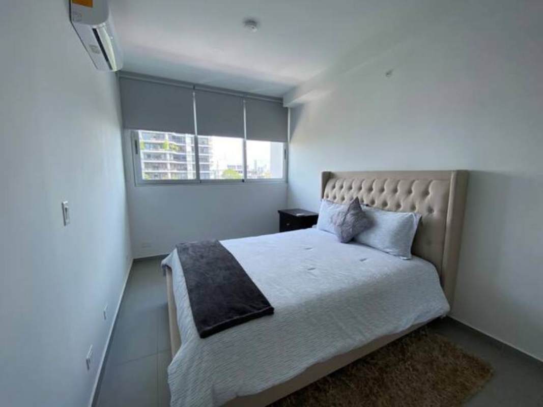 Open-plan living and dining room leading to balcony in PH Signature Point Panama City